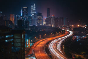 A Breathtaking View Of Kuala Lumpur's City Lights. Wallpaper