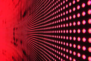 A Bright Red Led Lightshines Onto A Wall Wallpaper