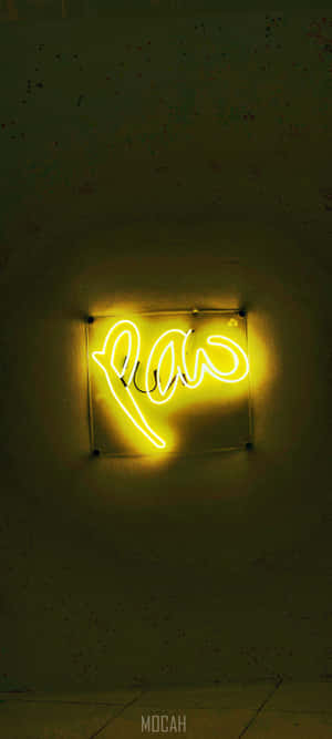 A Bright Yellow Neon Light Shines In The Night Wallpaper