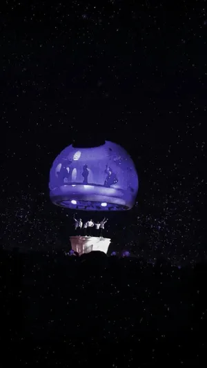 A Bts Army Bomb Illuminating The Night Sky At A Concert Wallpaper