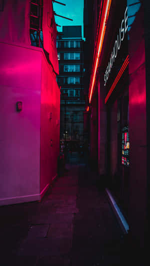 A Building With A Neon Sign Wallpaper