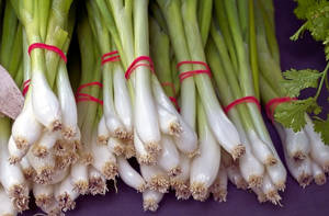 A Bundle Of Spring Onions Tied With Red Strings Wallpaper