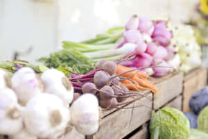 A Bustling Farmers Market Scene With Customers Shopping For Fresh Produce Wallpaper