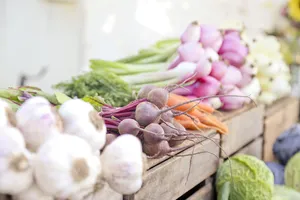 A Bustling Farmers Market Scene With Customers Shopping For Fresh Produce Wallpaper