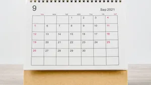 A Calendar With A White Background On A Wooden Table Wallpaper