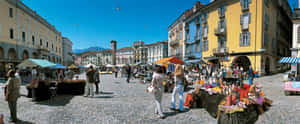 A Captivating Aerial View Of Locarno City With Lake Maggiore In The Background. Wallpaper