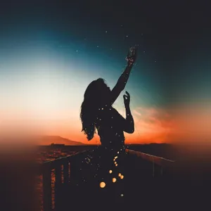 A Captivating Sunset Silhouette Of Trees And A Person Wallpaper