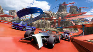 A Car Driving Down A Track In A Video Game Wallpaper