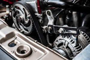 A Car Engine With A Belt And A Spark Plug Wallpaper