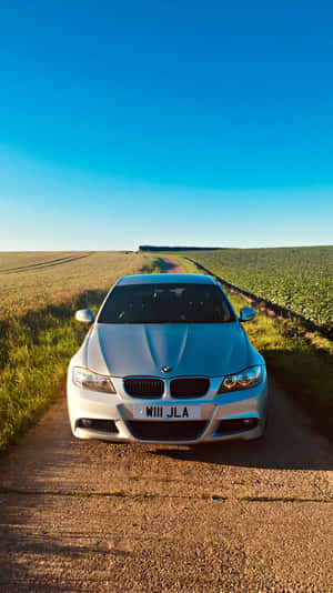 A Car Parked On A Dirt Road Wallpaper