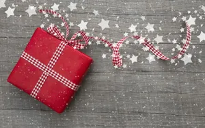 A Charming Red Gift Box Adorned With Twinkling Cute Stars. Wallpaper