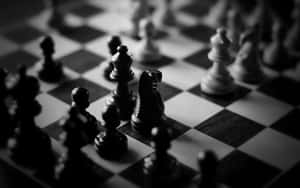 A Chess Board Set Up For Battle In Striking Black And White Wallpaper