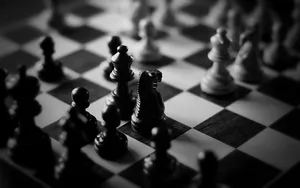 A Chess Board Set Up For Battle In Striking Black And White Wallpaper