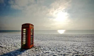 A Chilly Stroll On A Snowy Coastline Wallpaper