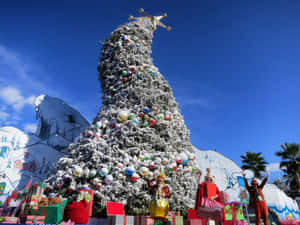 A Christmas Tree With A Large Number Of Presents On It Wallpaper