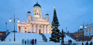 A Church With A Large White Dome And A Snow Covered Square Wallpaper