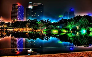 A City At Night With Lights Reflecting In The Water Wallpaper