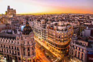 A City At Sunset With Buildings And Cars Wallpaper