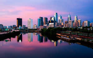 A City Skyline Is Seen From A River Wallpaper