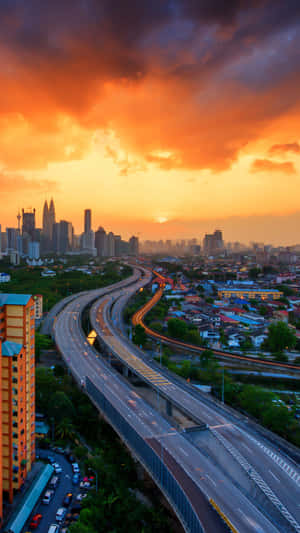 A City Skyline With A Cloudy Sky Wallpaper