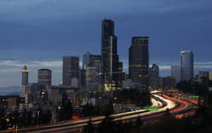 A City Skyline With A Highway Wallpaper