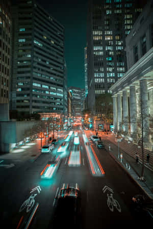 A City Street With Cars And Buildings Wallpaper