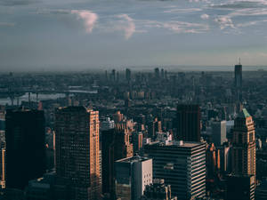 A Cityscape View Under A Grey Sky Wallpaper