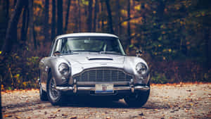 A Classic Aston Martin Db5 On The Road Wallpaper