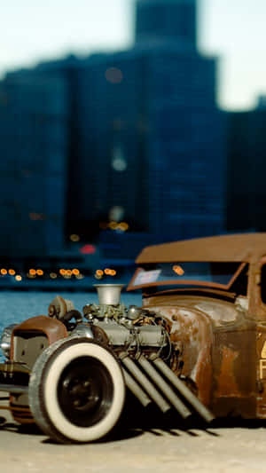 A Classic Blue Car With An Iphone Resting Inside Wallpaper