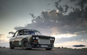 A Classic Datsun Vehicle Cruising On An Open Road Wallpaper
