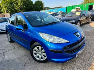 A Classy White Peugeot 207 On Open Road Wallpaper