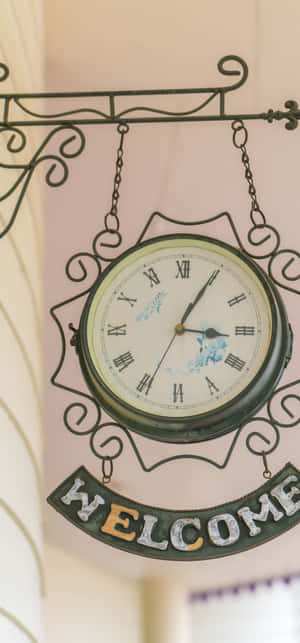 A Clock Hanging From A Wall Wallpaper