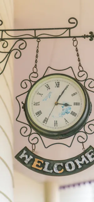 A Clock Hanging From A Wall Wallpaper