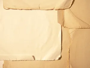 A Close-up Image Of Paper With Torn Edges Wallpaper