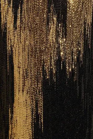 A Close Up Of A Black And Gold Sequin Dress Wallpaper