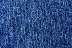 A Close Up Of A Blue Denim Fabric Wallpaper