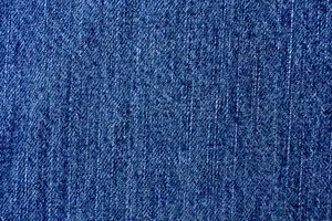 A Close Up Of A Blue Denim Fabric Wallpaper