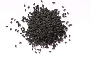 A Close Up Of A Bowl Of Black Cumin Wallpaper