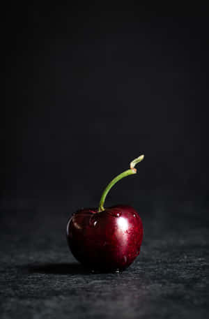 A Close-up Of A Fresh Black Cherry. Wallpaper