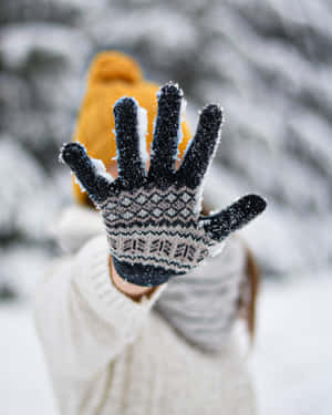 A Close-up Of Cozy Mittens On A Wooden Background Wallpaper