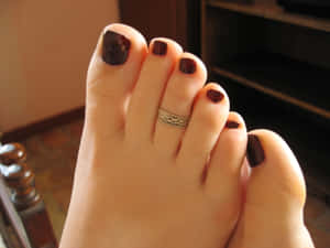 A Close-up Shot Of A Smooth, Beautifully Manicured Toe Embellished With A Toe Ring. Wallpaper