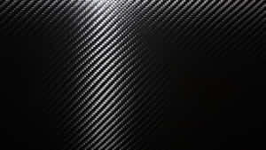 A Close-up View Of Black Carbon Fiber In A Luxurious Pattern Wallpaper