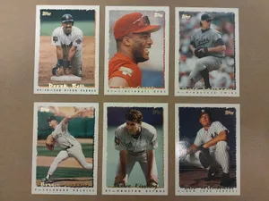 A Collection Of Vintage Baseball Cards Scattered On A Wooden Background Wallpaper