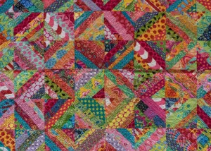 A Colorful Quilt With Many Colorful Squares Wallpaper