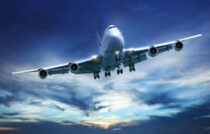 A Commercial Passenger Aircraft Takes Off Into The Clear Blue Sky Wallpaper