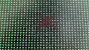 A Computer Screen With A Red And Green Bug Wallpaper