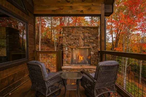 A Cozy Fall Cabin Surrounded By Vibrant Autumn Foliage. Wallpaper