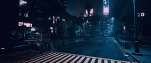 A Dark City Street With Neon Lights And A Crosswalk Wallpaper