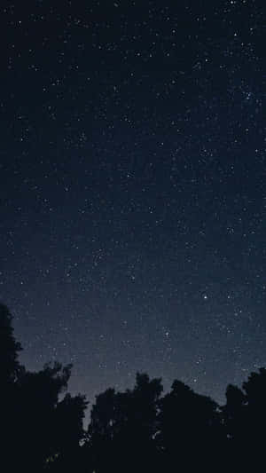 A Dark Starry Night Sky With Stars Illuminated In The Night Sky. Wallpaper