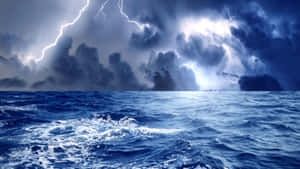 A Deadly Storm Crashing Against The Ocean Waves Wallpaper